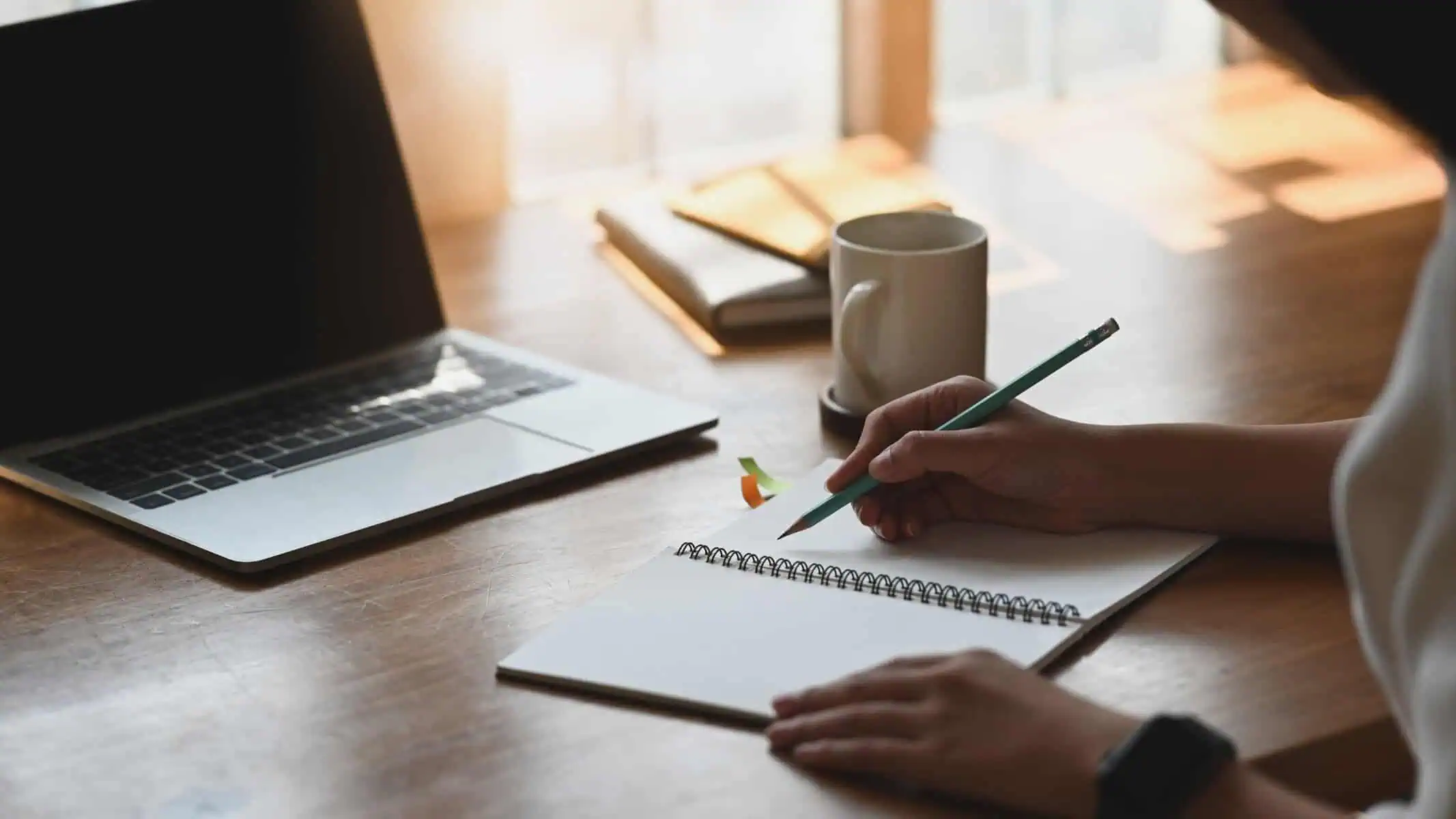A person taking notes of advice from creative professionals who made it