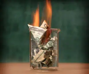 Money being burnt that was wasted on extravagant designs for print