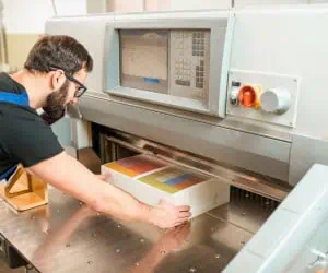 A professional printing service using a guillotine stack cutter
