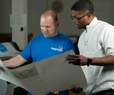 Graphic designer working with printer on proof drafts